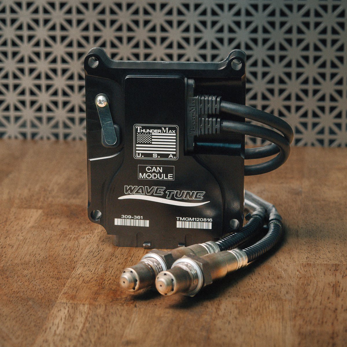ThunderMax 309-361 ECM and wideband oxygen sensors displayed on a wooden workbench