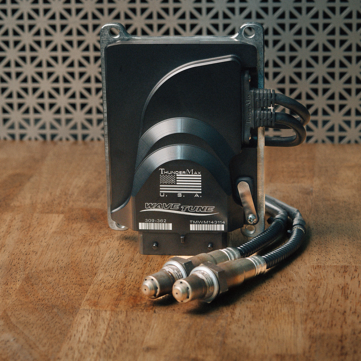 ThunderMax 309-362 ECM and wideband oxygen sensors displayed on a wooden workbench