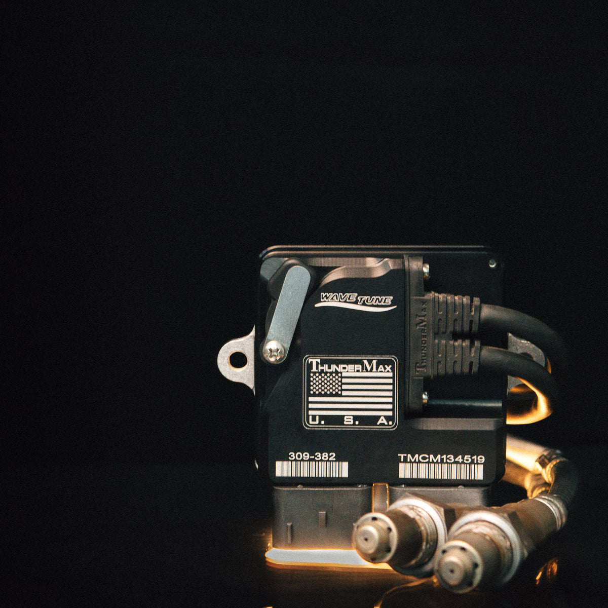 ThunderMax 309-382 ECM and wideband oxygen sensors against a dark background