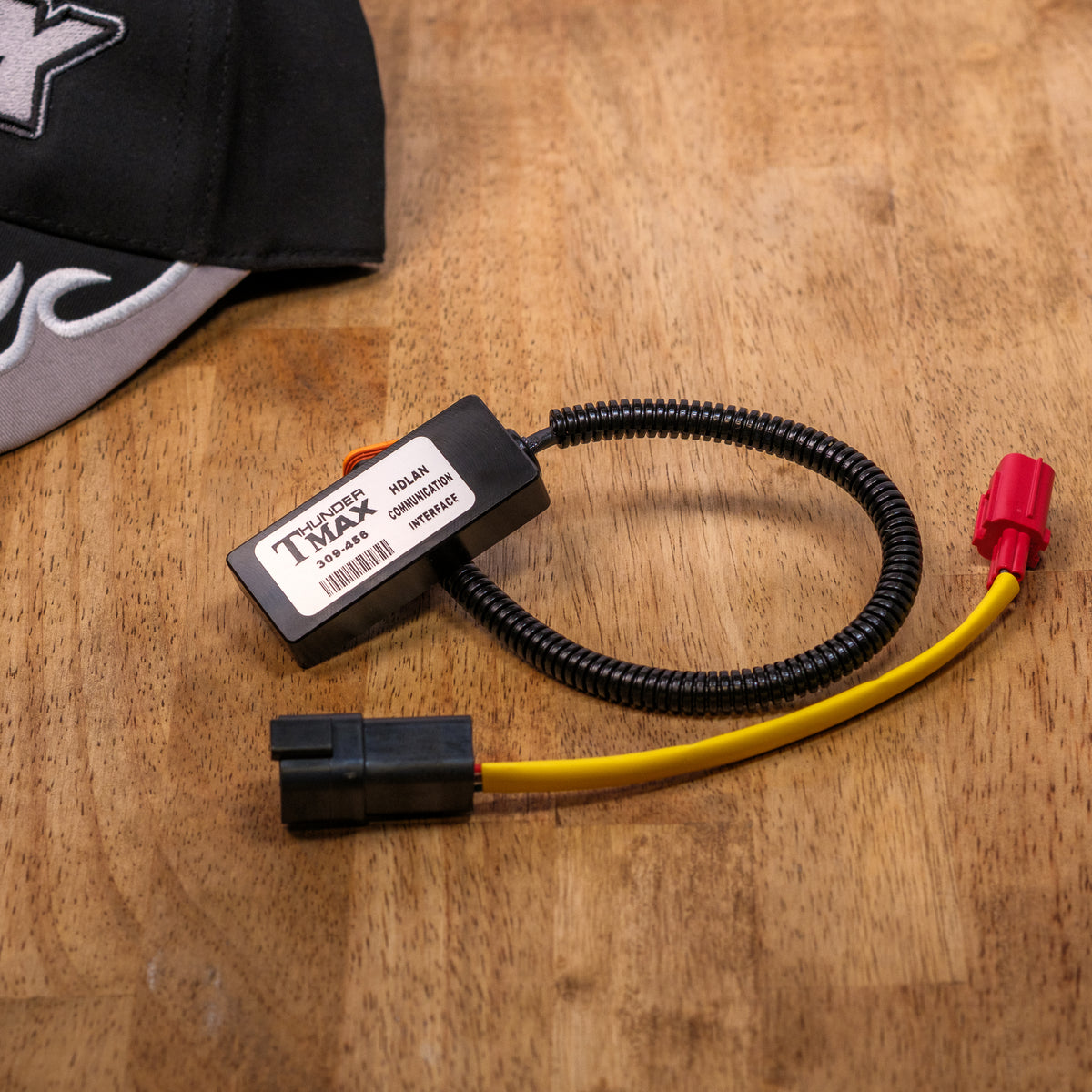 ThunderMax 309-456 HDLAN communication module and connector leads on a wooden surface