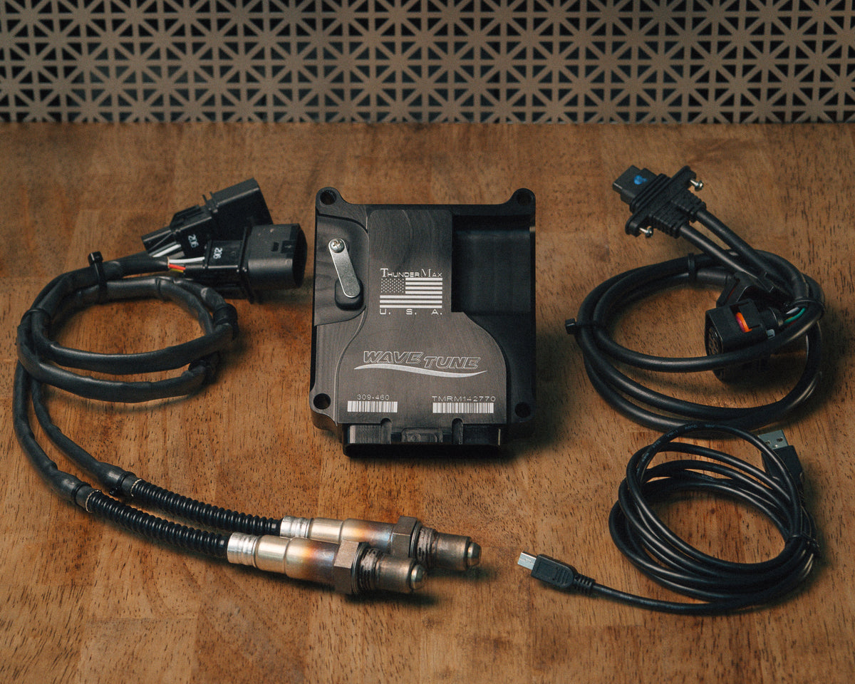 ThunderMax 309-460 ECM, wideband oxygen sensors and wiring laid out on a wooden workbench