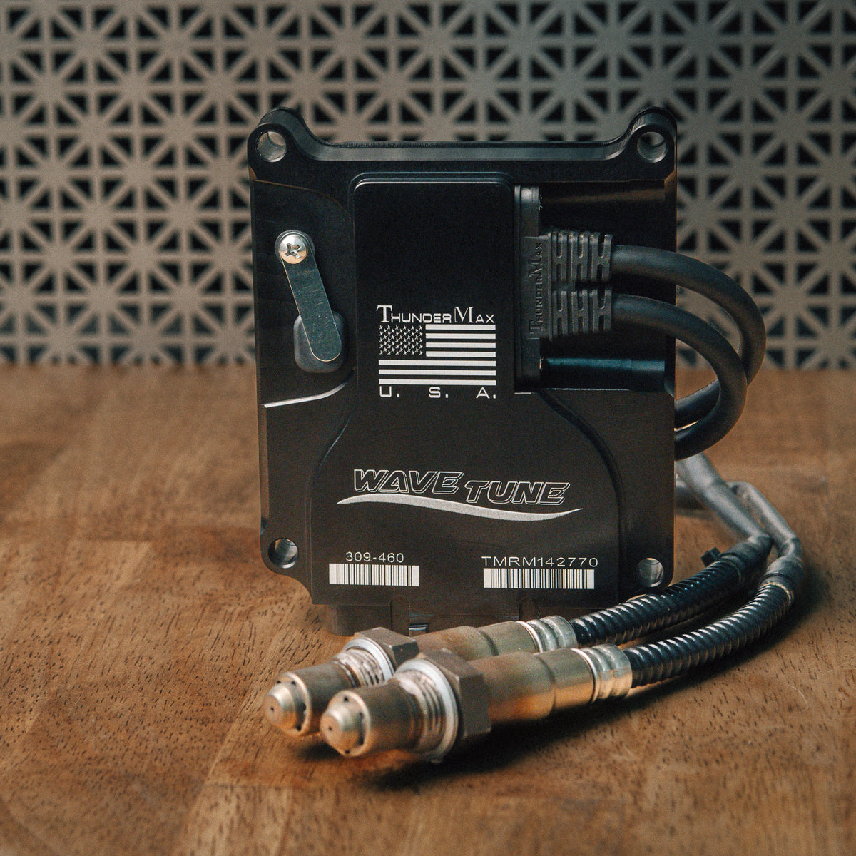 ThunderMax 309-460 ECM and wideband oxygen sensors displayed on a wooden workbench