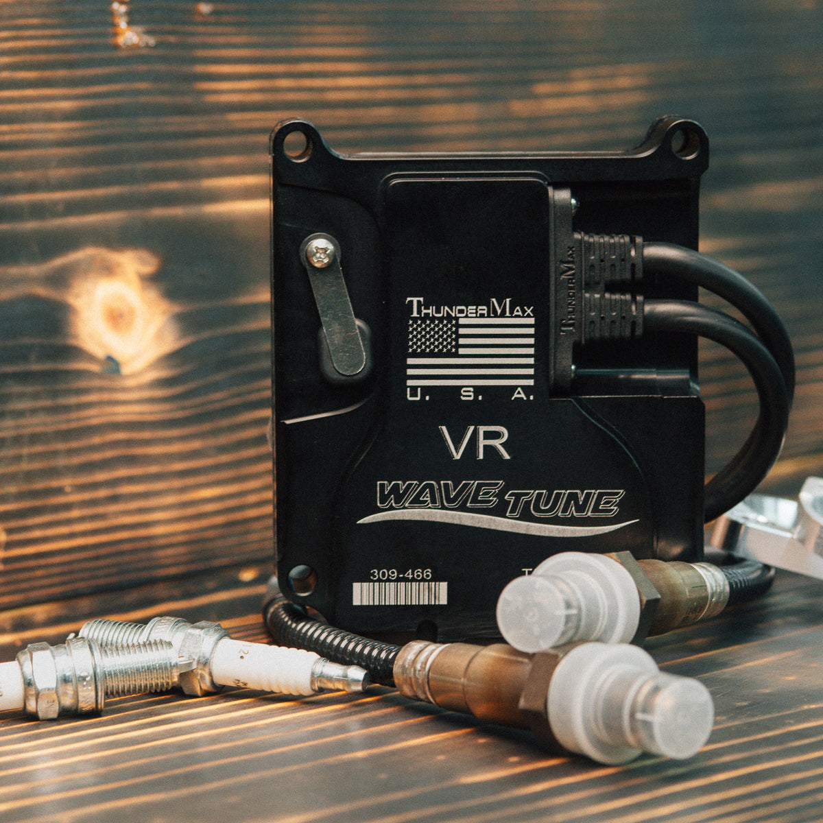 ThunderMax 309-466 ECM and wideband oxygen sensors on a wooden workbench