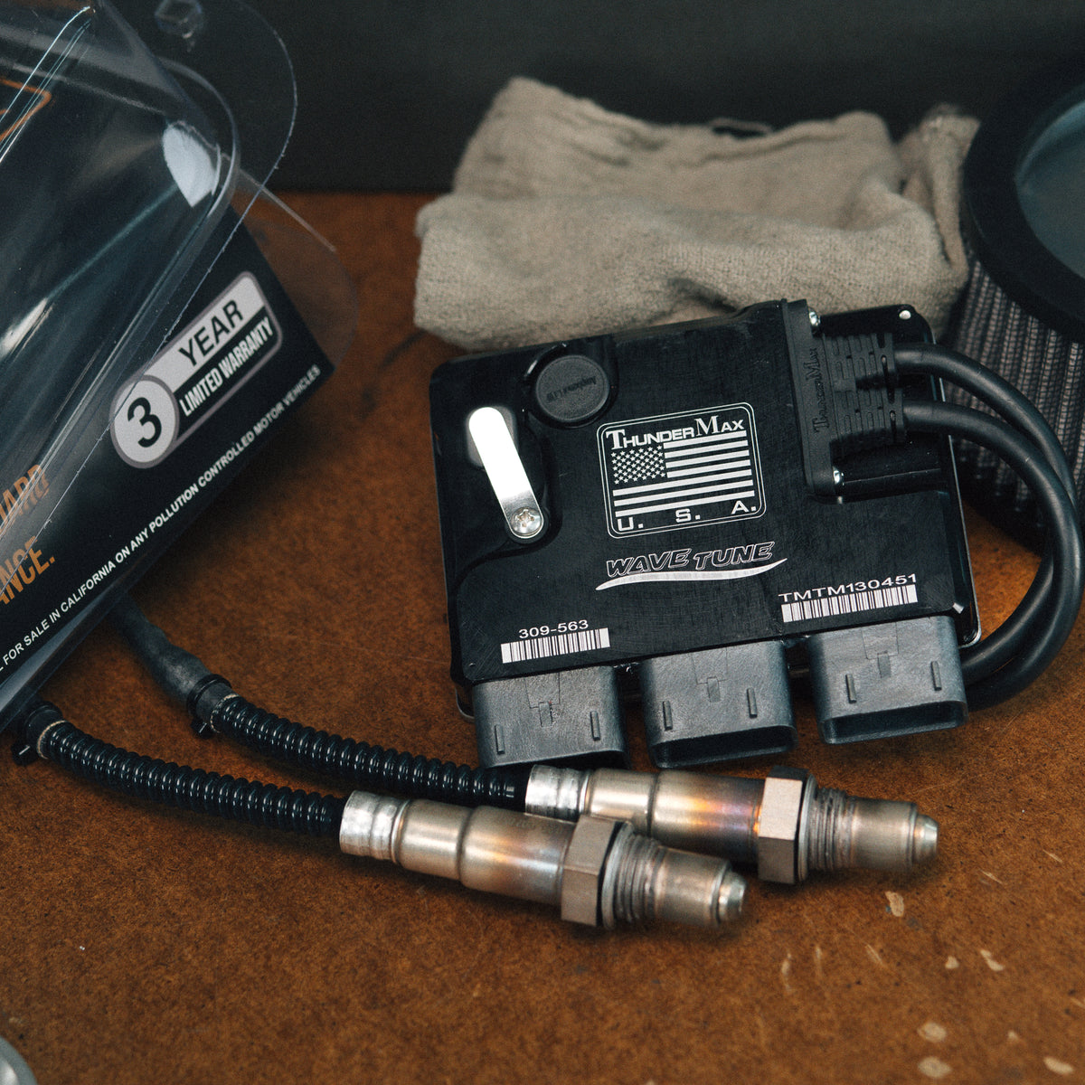 ThunderMax 309-563 ECM and wideband oxygen sensors beside a shop towel