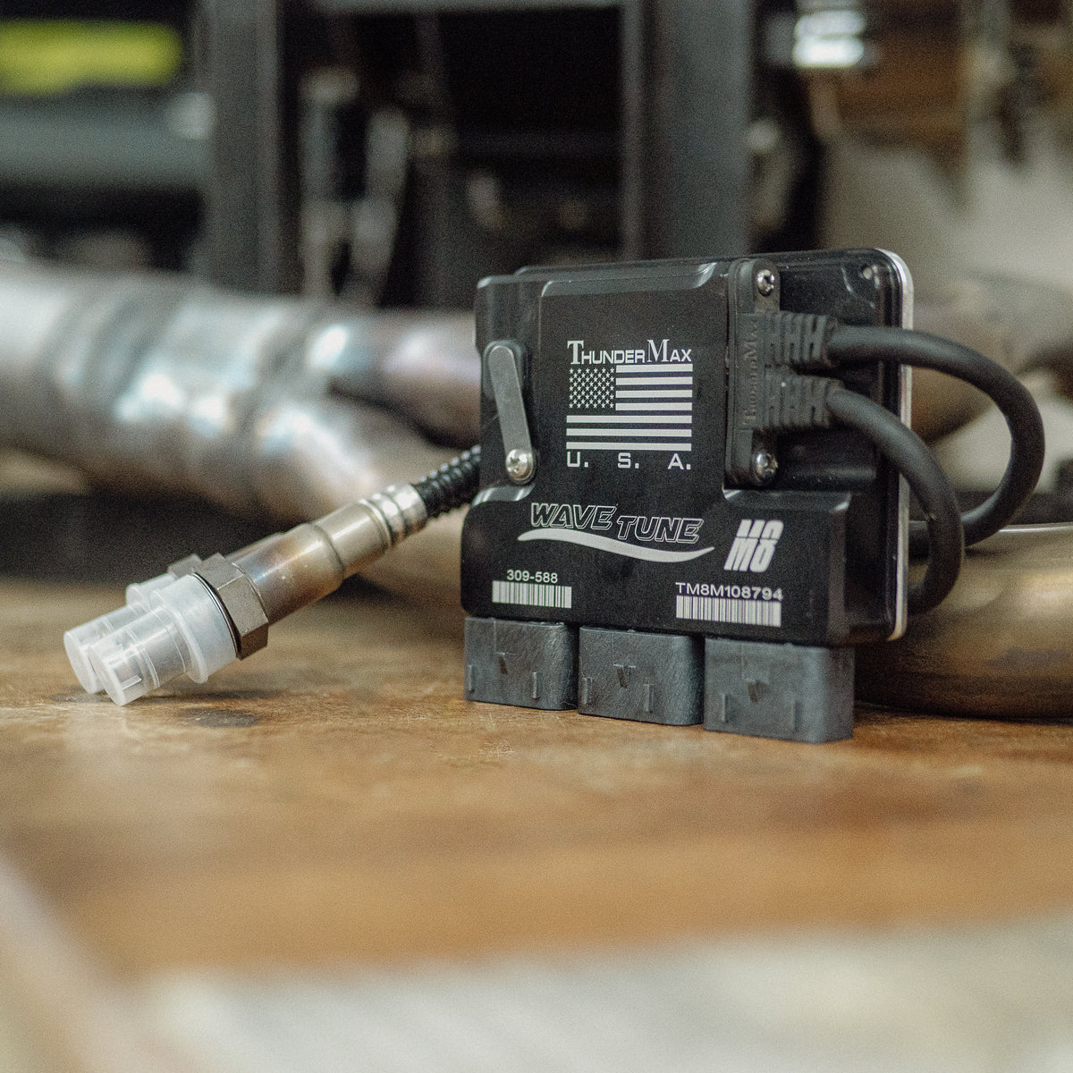 ThunderMax 309-588 ECM and wideband oxygen sensors on a wooden workbench