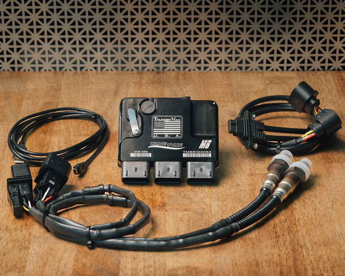 ThunderMax 309-589 ECM, wideband oxygen sensors and wiring laid out on a wooden workbench