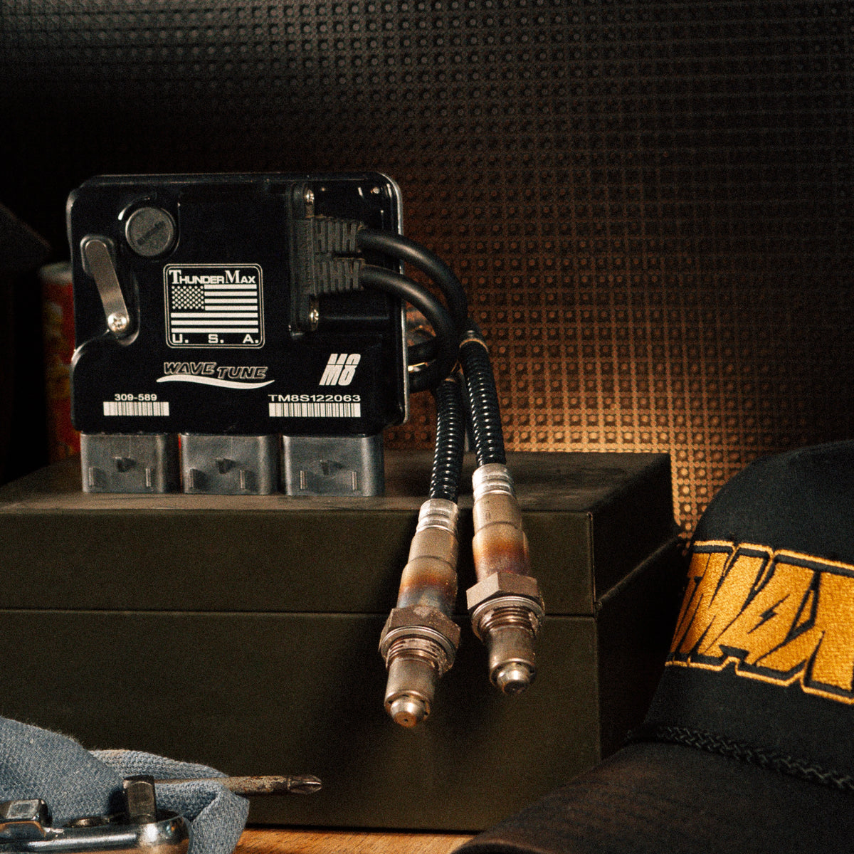 ThunderMax 309-589 ECM and wideband oxygen sensors displayed on a metal toolbox