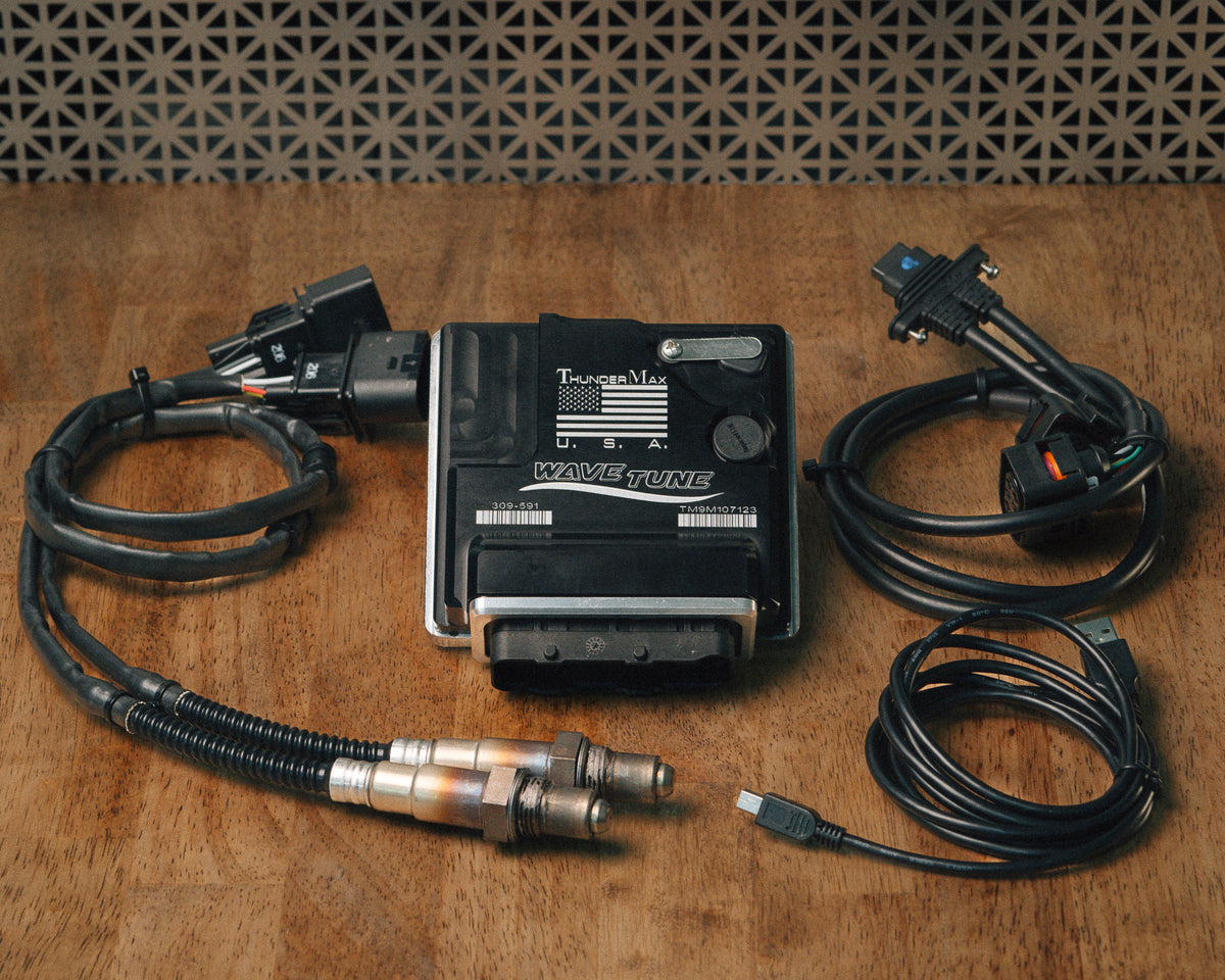 ThunderMax 309-591 ECM, wideband oxygen sensors and wiring laid out on a wooden workbench