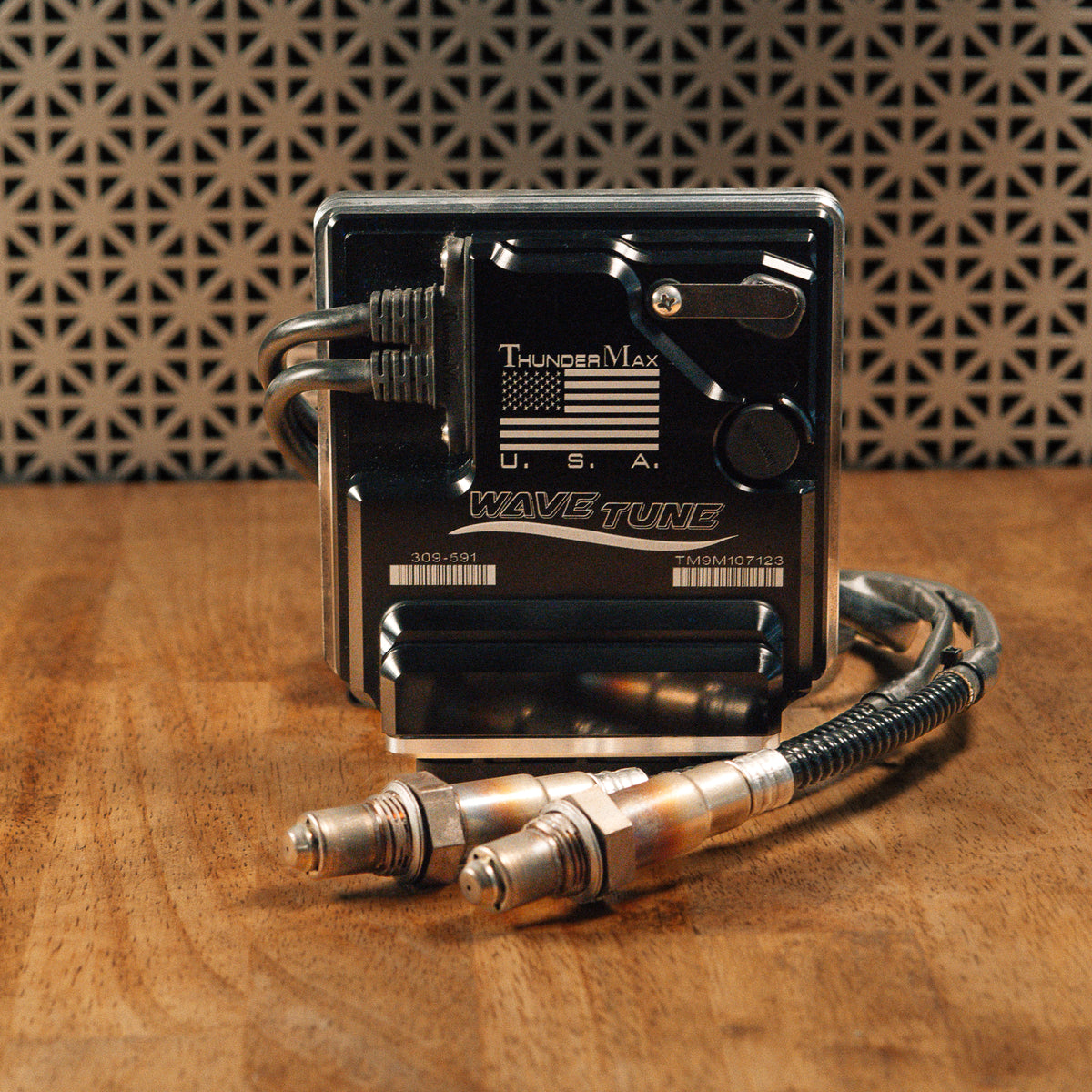 ThunderMax 309-591 ECM and wideband oxygen sensors displayed on a wooden workbench