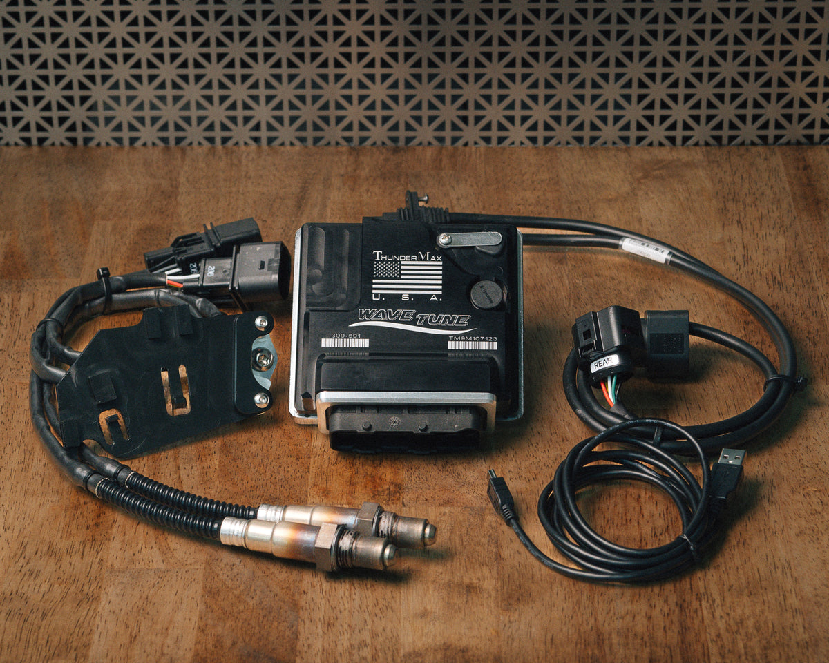 ThunderMax 309-592 ECM, wideband oxygen sensors and wiring laid out on a wooden workbench