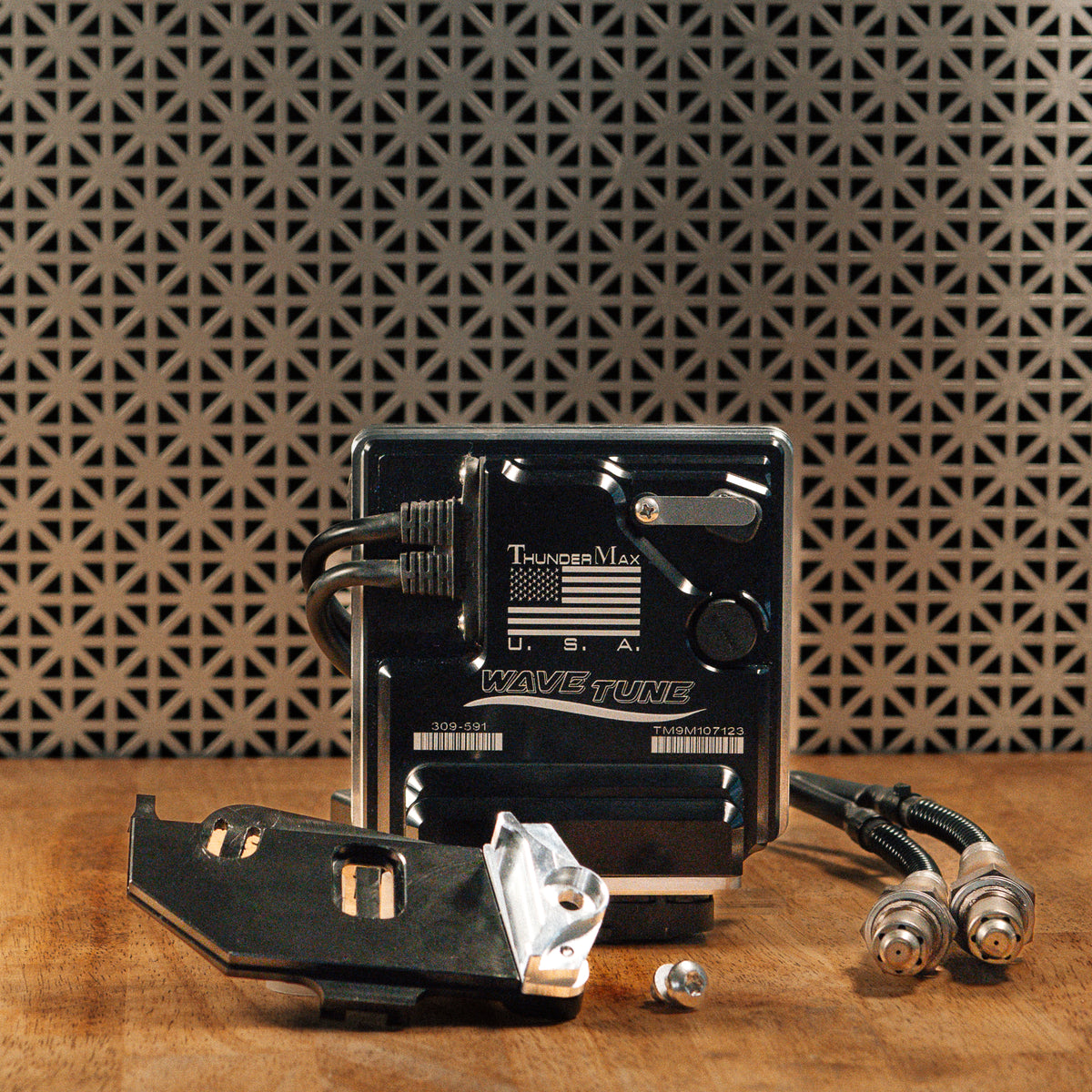 ThunderMax 309-592 ECM and wideband oxygen sensors displayed on a wooden workbench