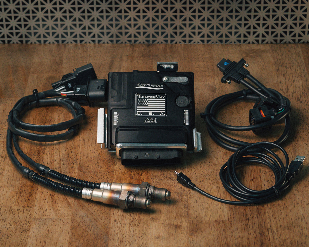 ThunderMax 309-606 ECM, wideband oxygen sensors and wiring laid out on a wooden workbench