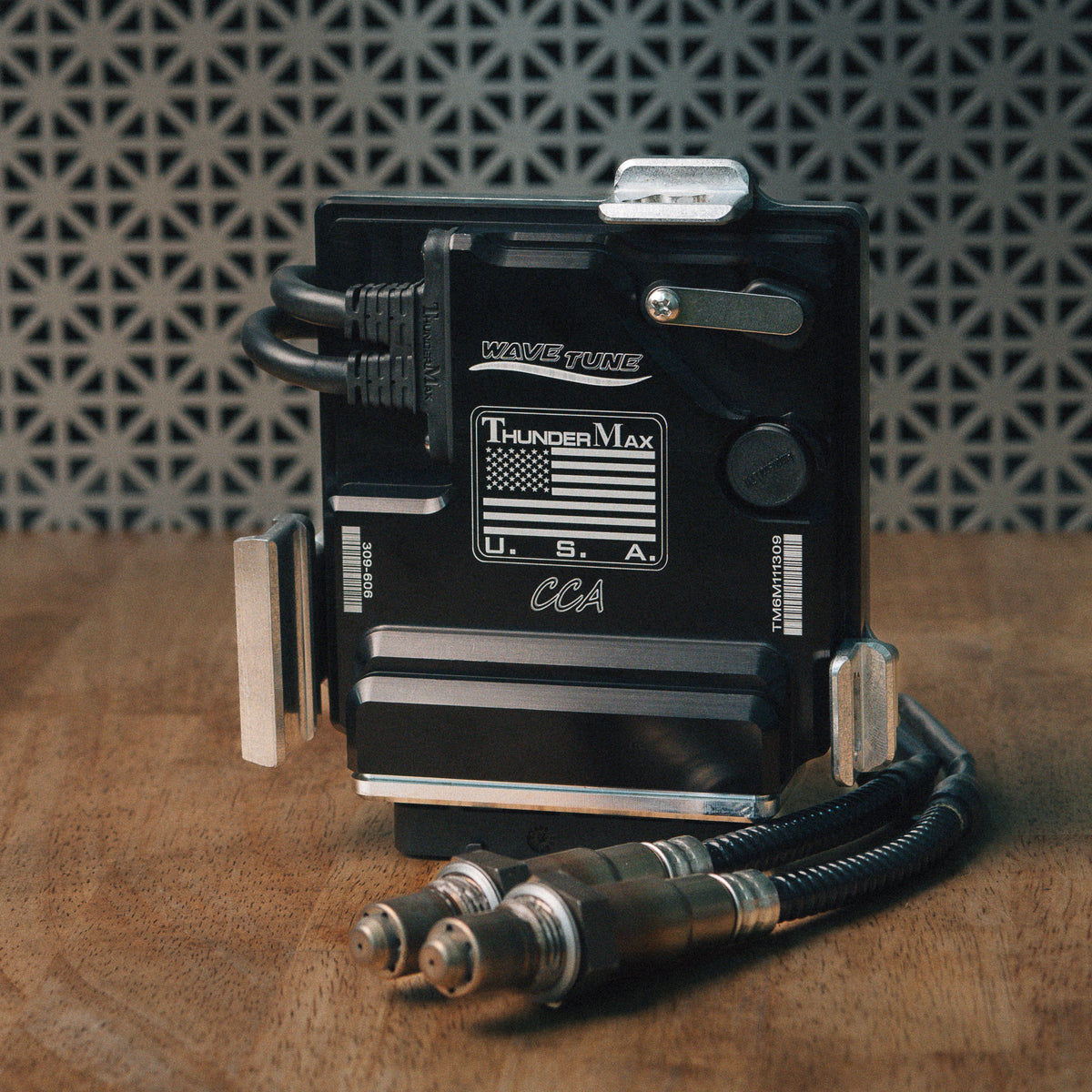 ThunderMax 309-606 ECM and wideband oxygen sensors displayed on a wooden workbench