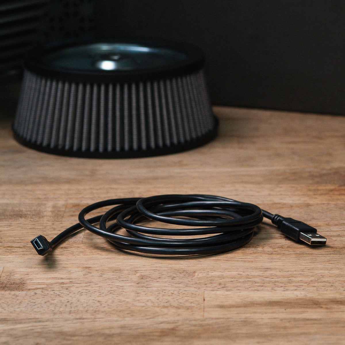 ThunderMax Mini-USB data cable coiled on a wooden workbench