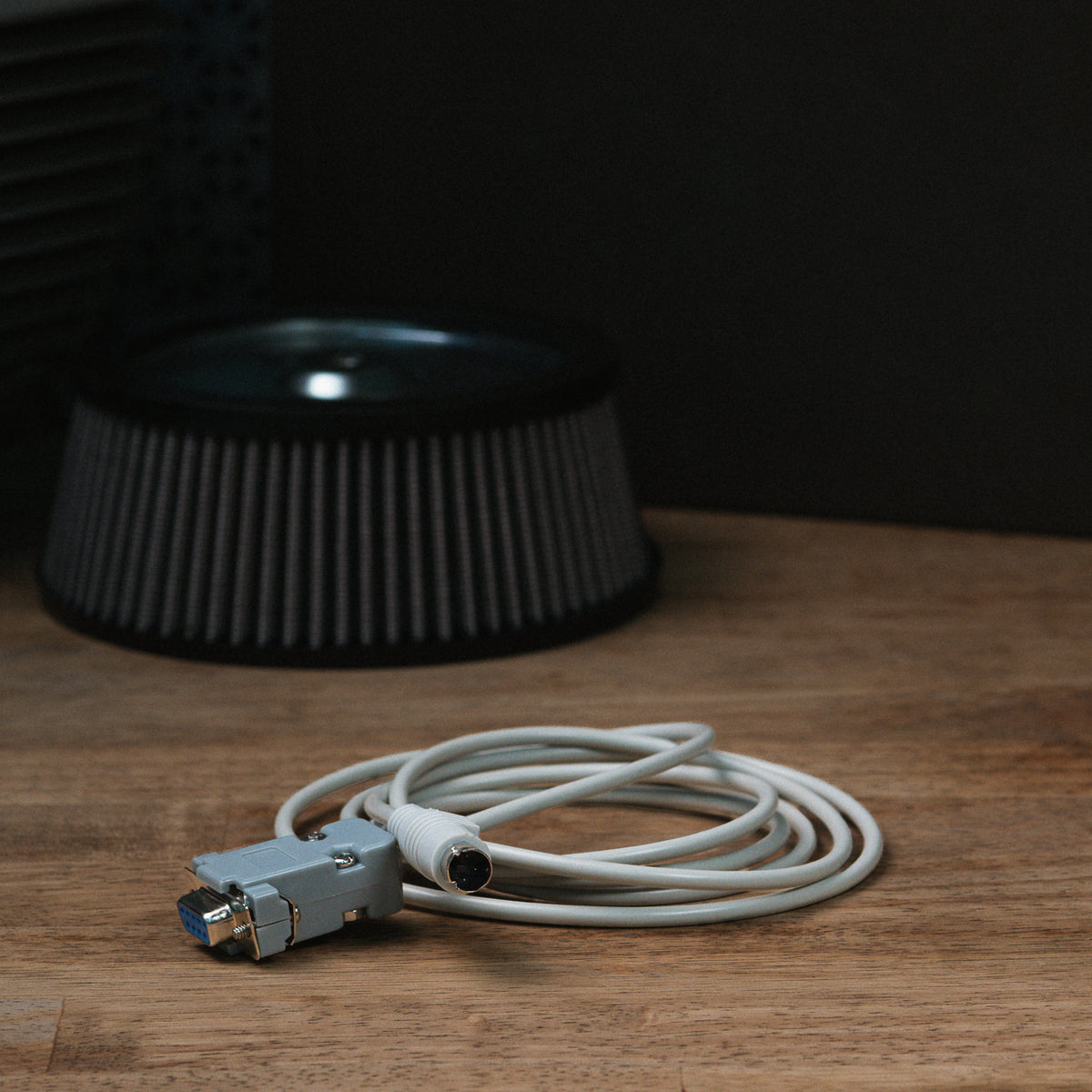 ThunderMax EA2100 serial data cable coiled on a wooden workbench