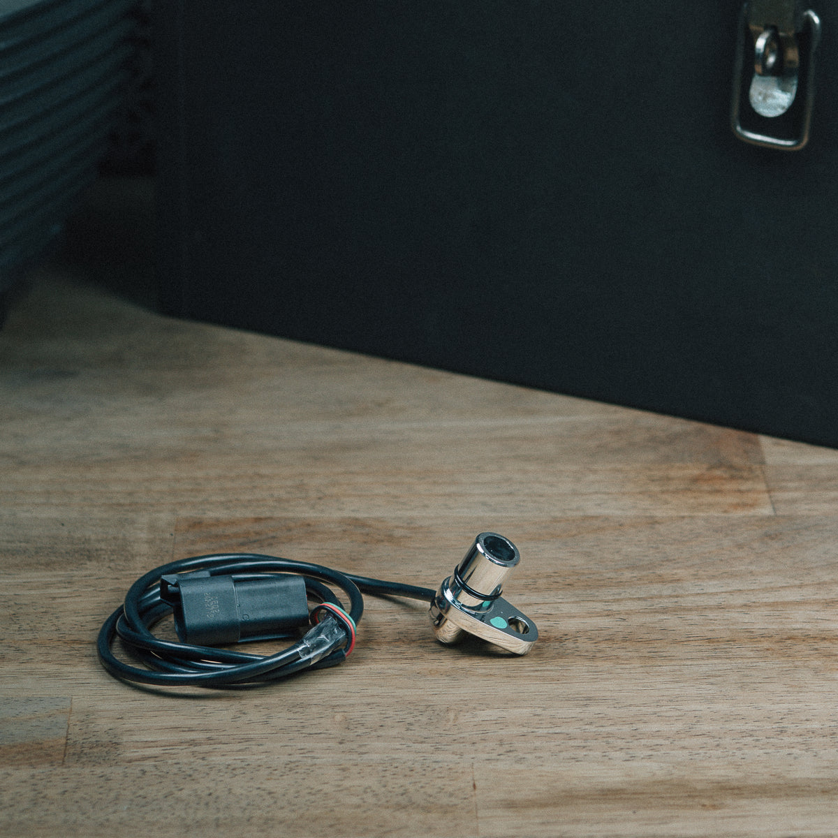 EA4100 transmission speed sensor and cable on a wooden workbench
