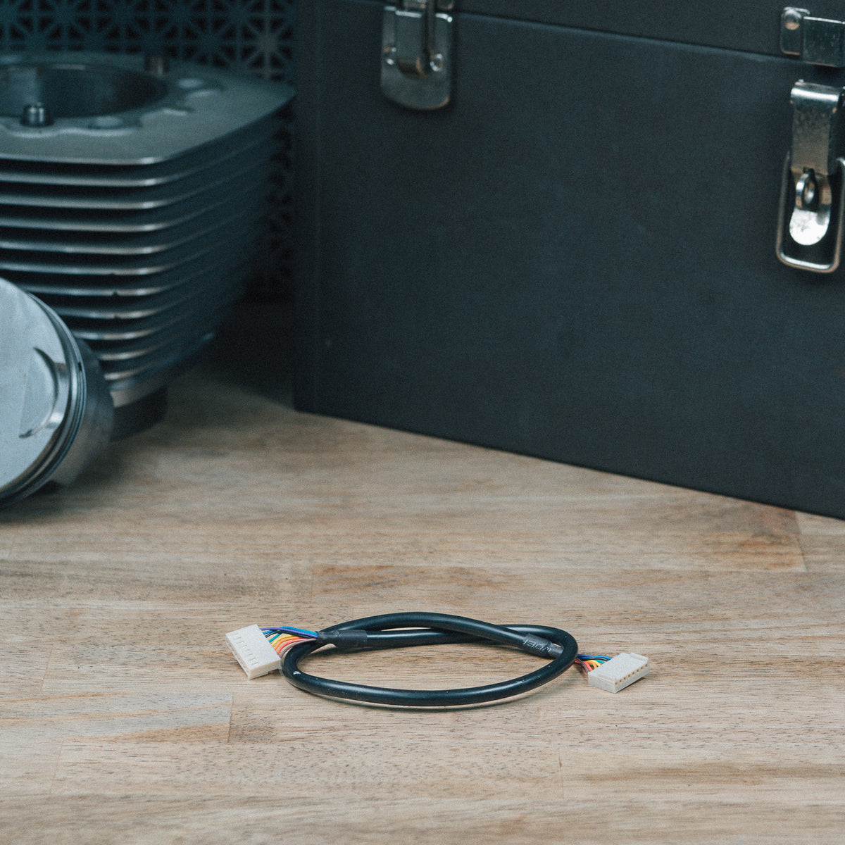 EHC LED indicator cable with connectors on a wooden workbench