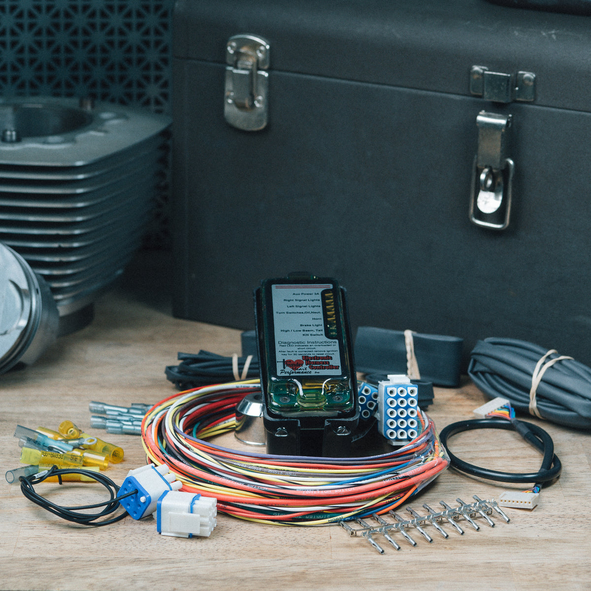 Electronic Harness Controller kit with wiring, connectors and hardware on a workbench