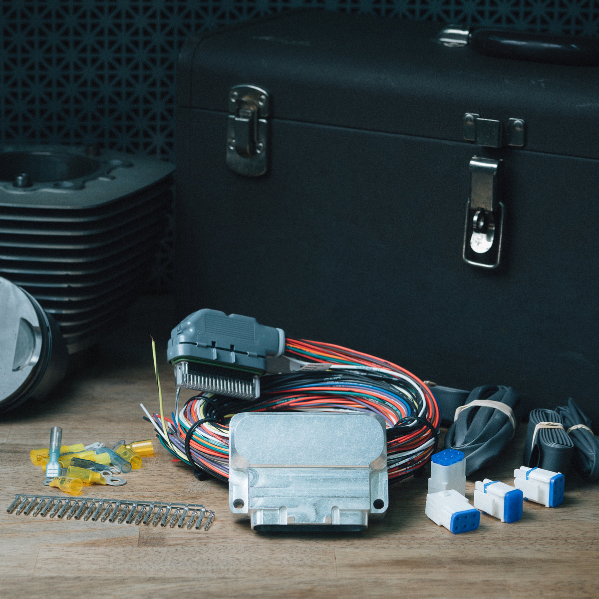 Micro Harness Controller kit with wiring, connectors and hardware on a workbench