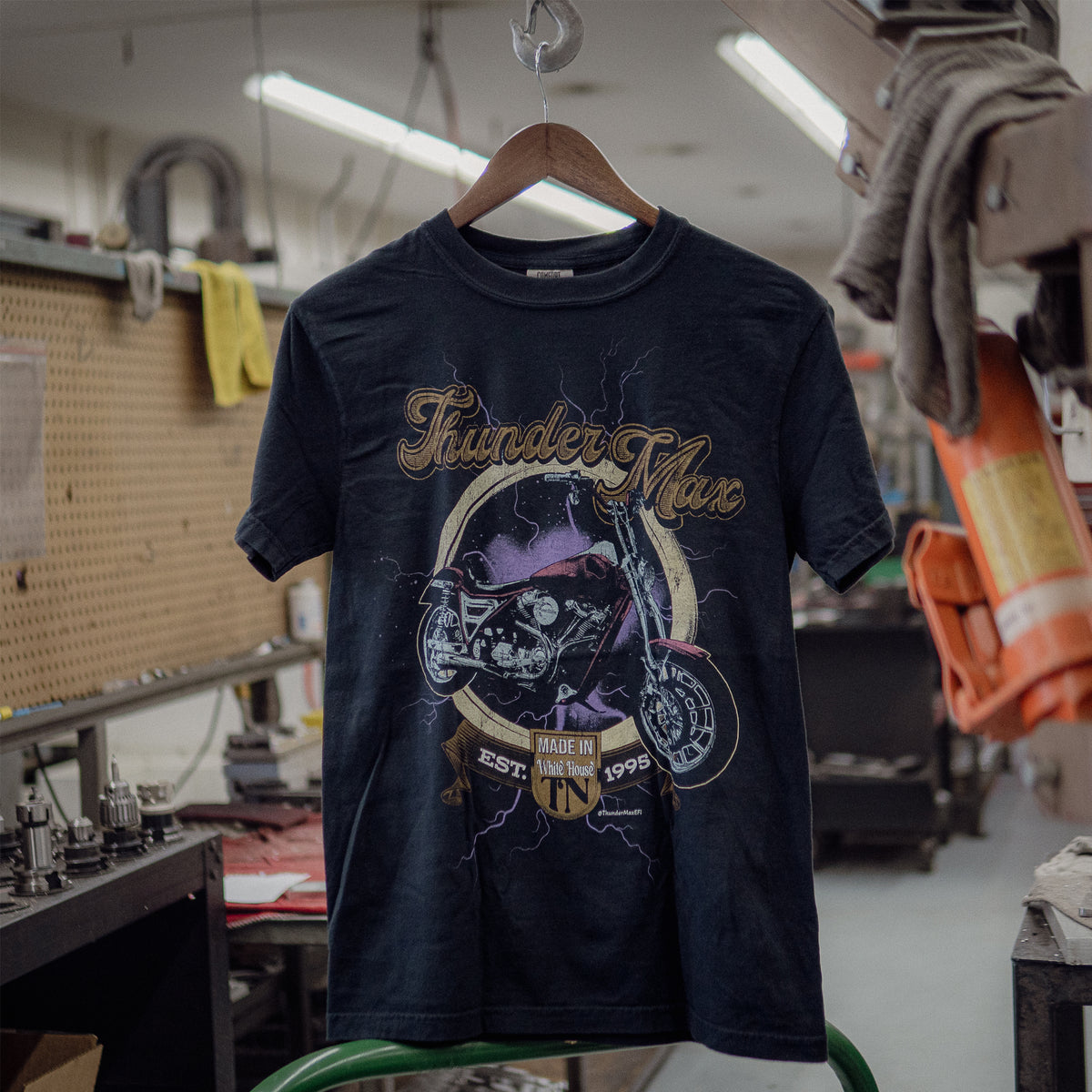 ThunderMax FXR Forever T-shirt hanging in a workshop