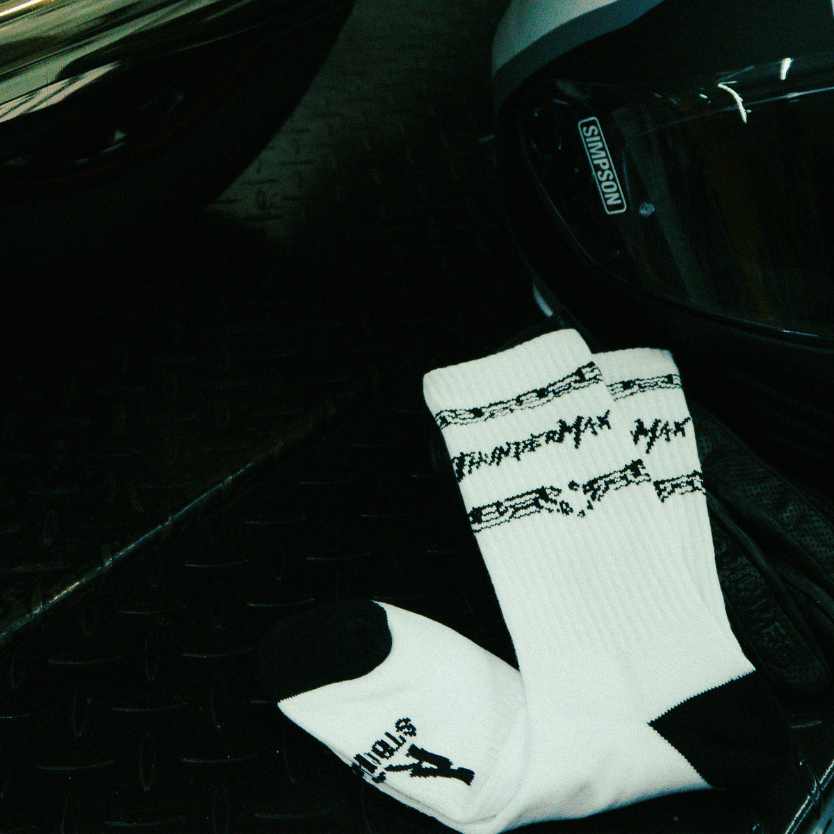 Unchained Performance socks showing black cuff graphics and branded lettering