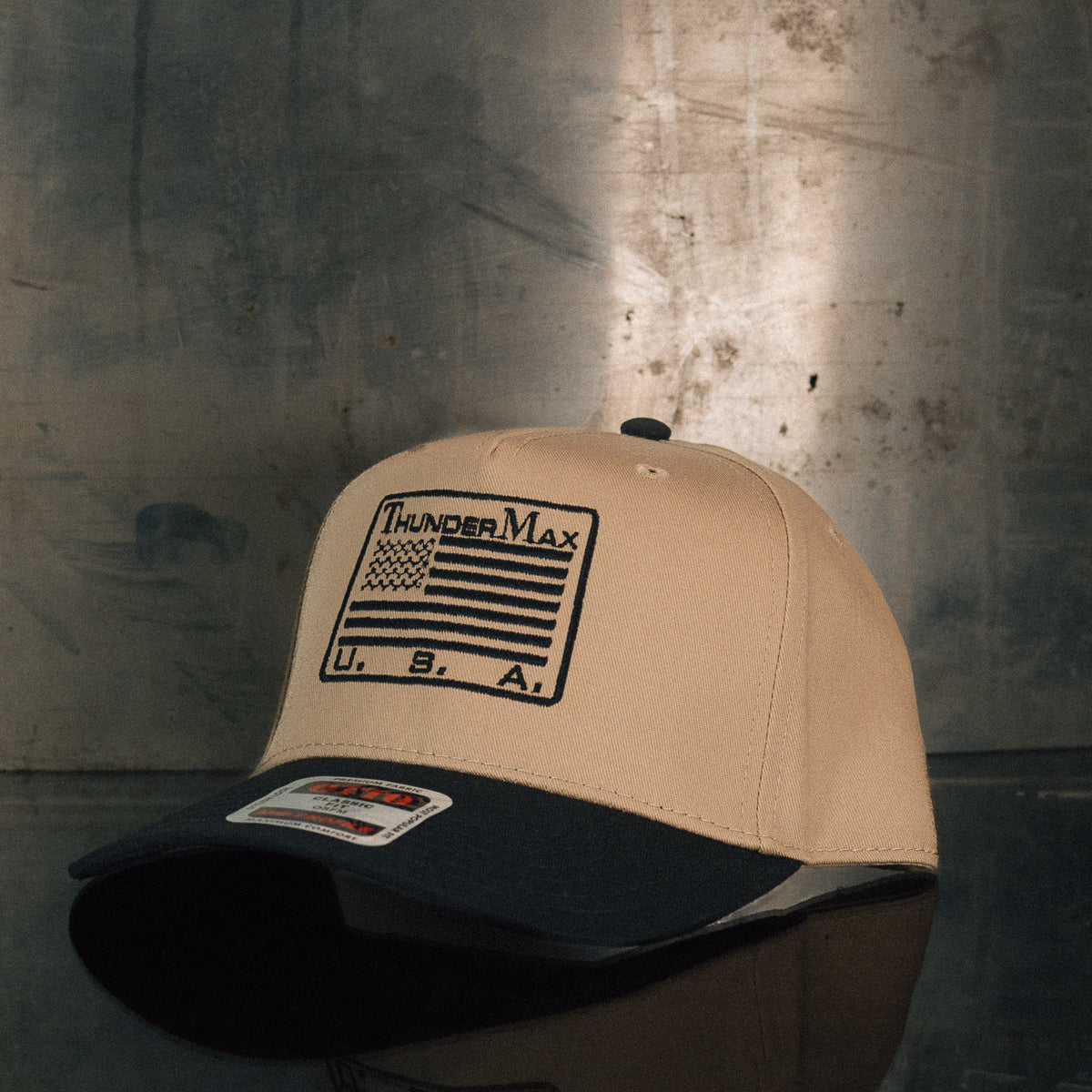 TMax Flag Steppin’ Out hat displayed against a metal background
