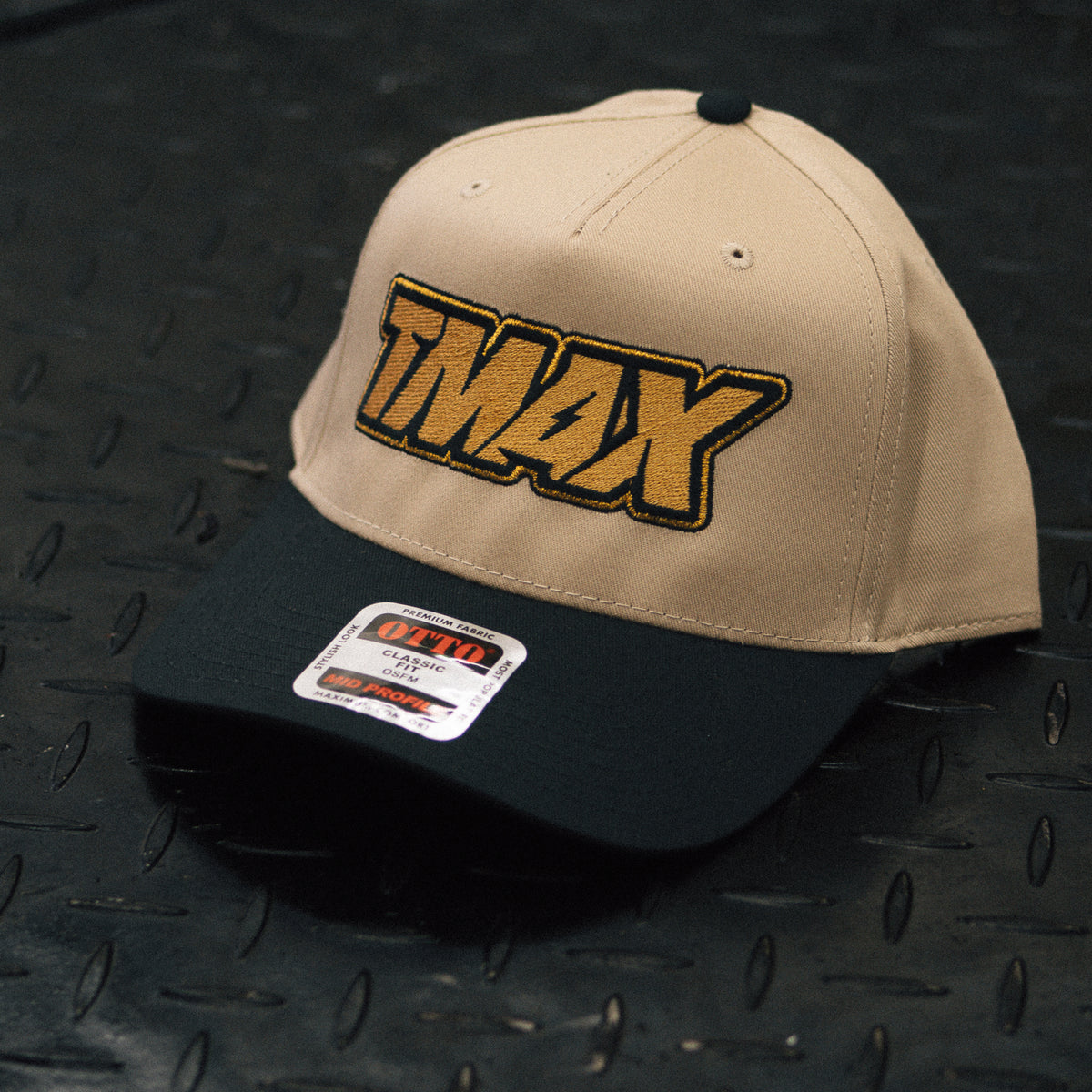 TMax Steppin’ Out hat showing the gold lettering and curved dark bill