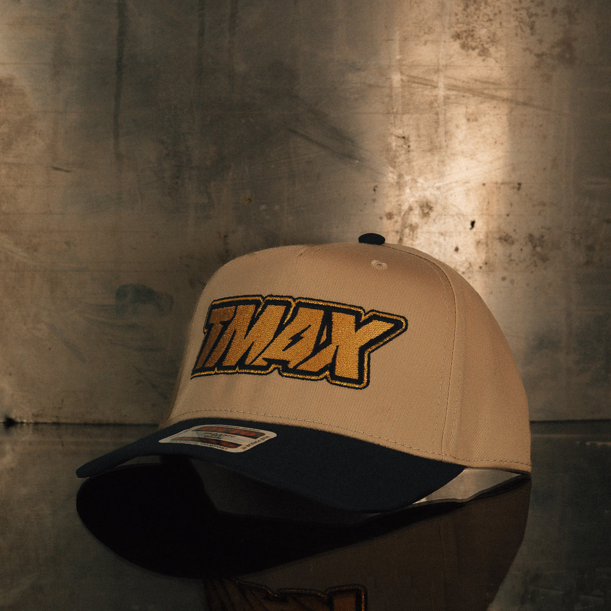 TMax Steppin’ Out hat displayed against a metal background